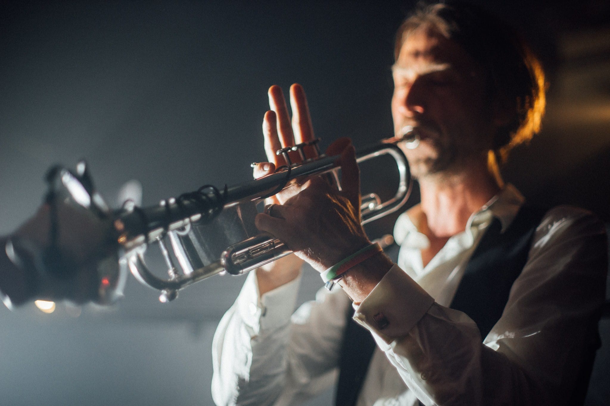 DJ mixing electro swing at a wedding with live trumpet performance
